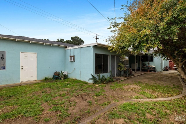 rear view of house with stucco siding