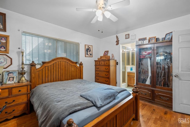 bedroom featuring connected bathroom, ceiling fan, and wood finished floors