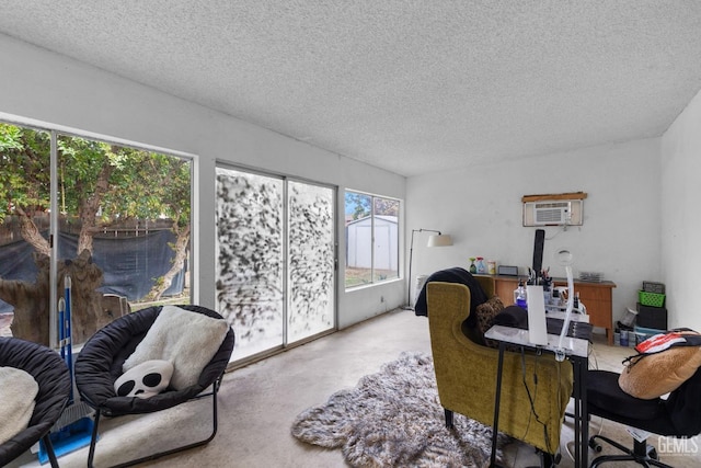 office with a wall mounted air conditioner and a textured ceiling