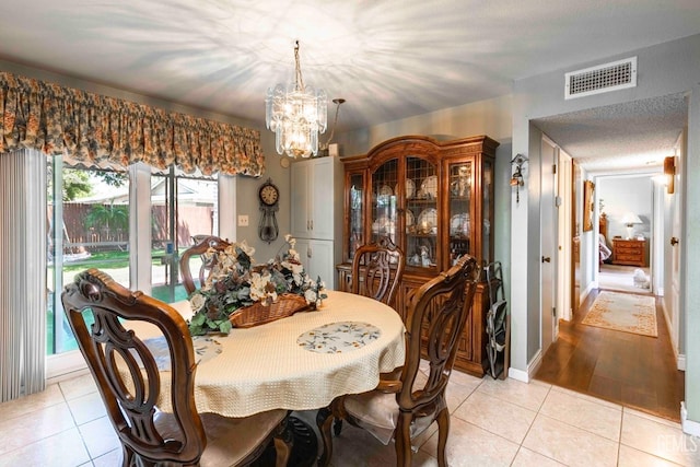 6012 Cumin Ln, Bakersfield, CA 93309 - dining space with light tile patterned floors and a chandelier