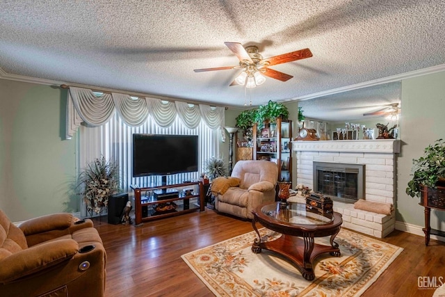 6012 Cumin Ln, Bakersfield, CA 93309 - living room with ceiling fan, a textured ceiling, a fireplace, ornamental molding, and wood finished floors