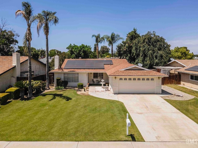 6012 Cumin Ln, Bakersfield, CA 93309 - view of front facade featuring a garage, solar panels, concrete driveway, and a chimney
