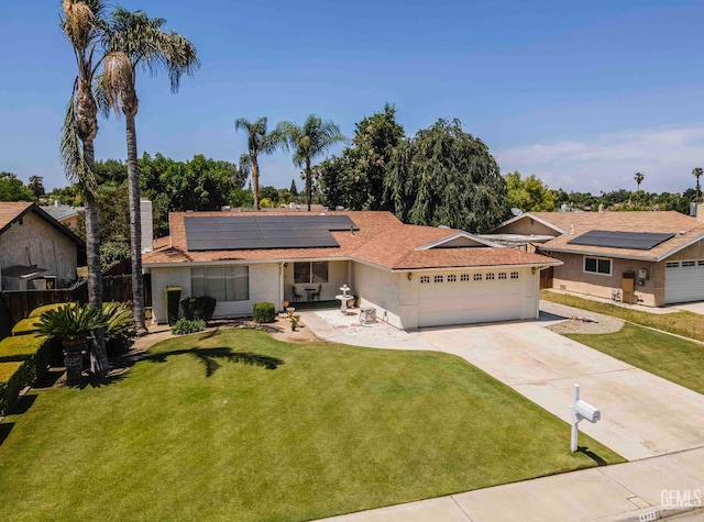 6012 Cumin Ln, Bakersfield, CA 93309 - ranch-style home with an attached garage, solar panels, driveway, stucco siding, and a shingled roof
