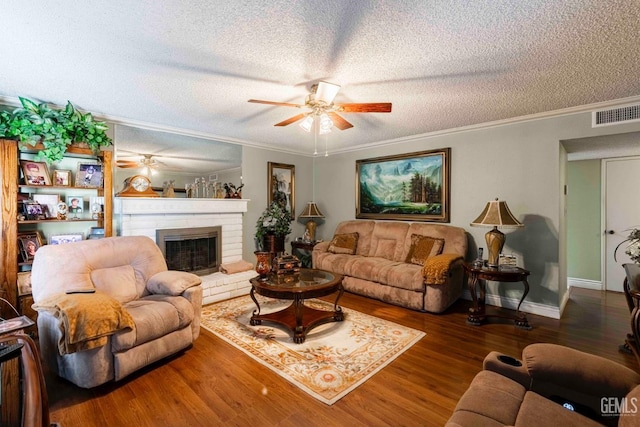 6012 Cumin Ln, Bakersfield, CA 93309 - living area featuring a ceiling fan, a textured ceiling, wood finished floors, a fireplace, and ornamental molding