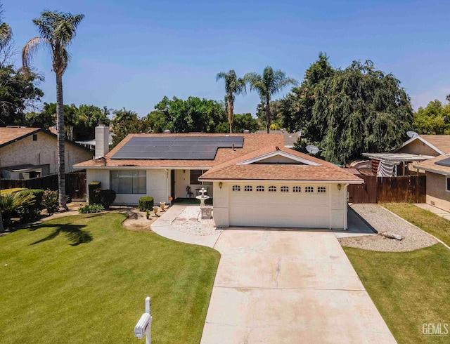 6012 Cumin Ln, Bakersfield, CA 93309 - single story home with concrete driveway, solar panels, an attached garage, roof with shingles, and stucco siding