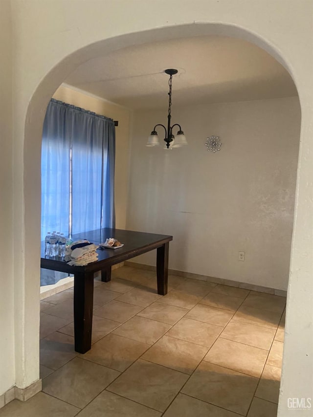 unfurnished dining area with tile patterned flooring and a notable chandelier