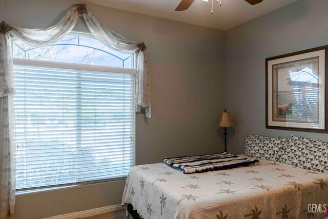 bedroom with baseboards and a ceiling fan
