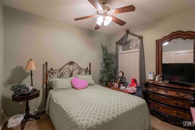 bedroom with ceiling fan and carpet floors