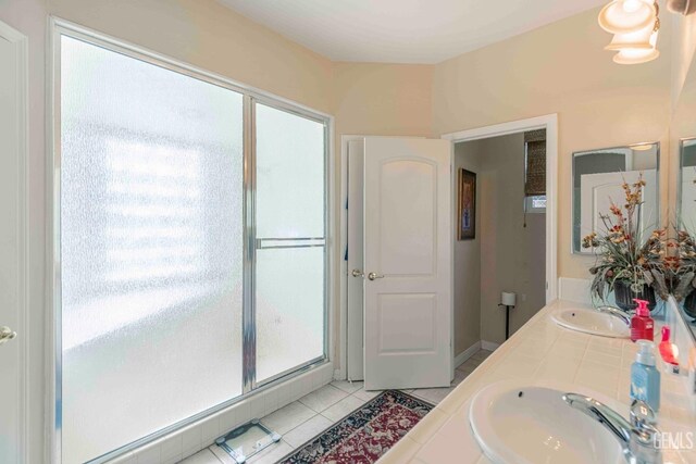 full bathroom with tile patterned floors, double vanity, and a sink