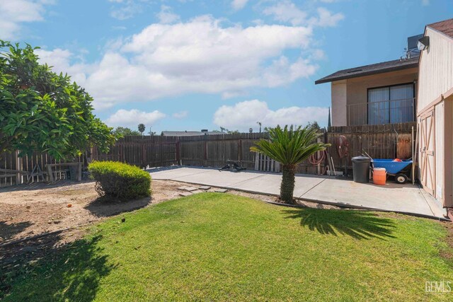 view of yard with a patio and a fenced backyard