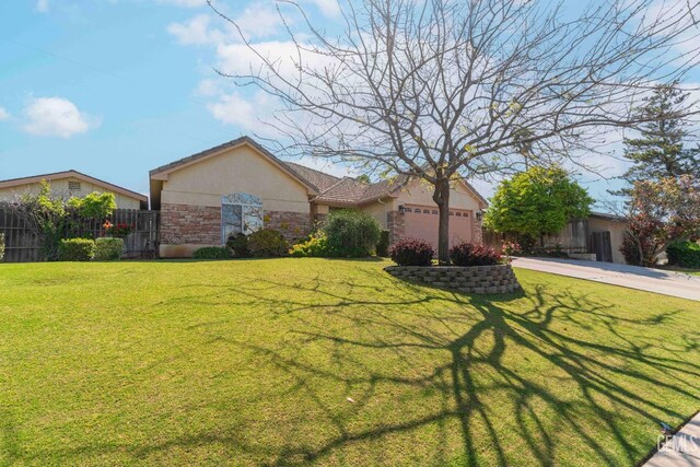 view of front of home featuring stucco siding, fence, stone siding, concrete driveway, and an attached garage