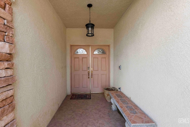 doorway to property featuring stucco siding