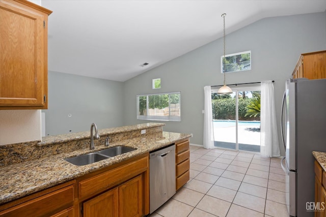 5836 S Greenhorn Mountain Ct, Bakersfield, CA 93313 - kitchen featuring stainless steel appliances, high vaulted ceiling, healthy amount of natural light, light tile patterned floors, and brown cabinets