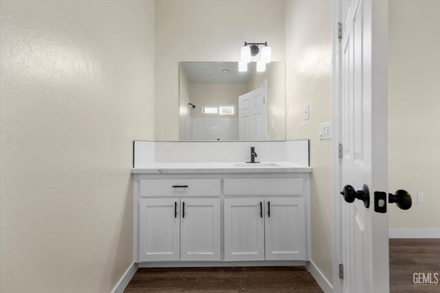 bathroom with vanity and wood-type flooring