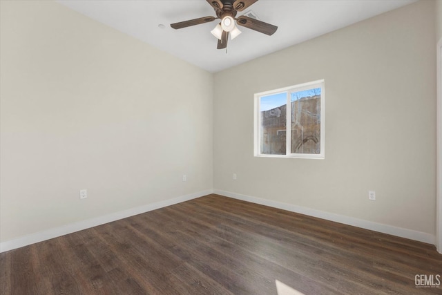 spare room with dark wood-type flooring and ceiling fan