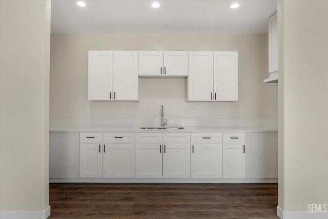 kitchen featuring sink, dark hardwood / wood-style floors, and white cabinets