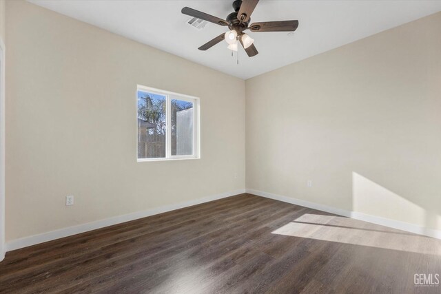 unfurnished room with dark wood-type flooring and ceiling fan