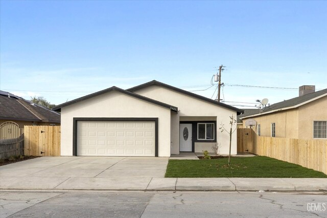 ranch-style house featuring a garage and a front yard