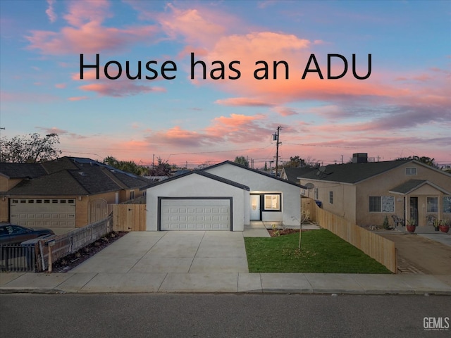 view of front of house with a yard and a garage