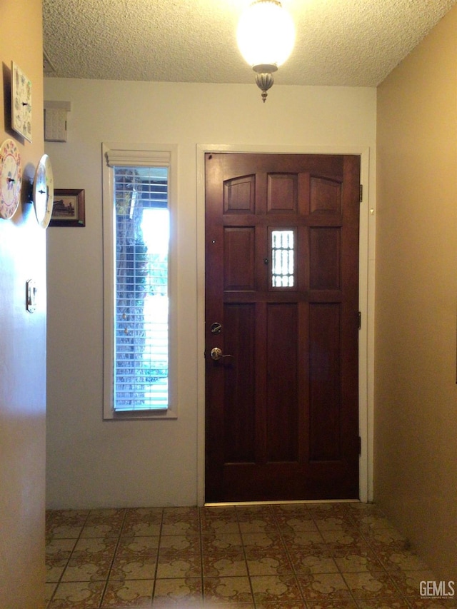 foyer featuring a textured ceiling