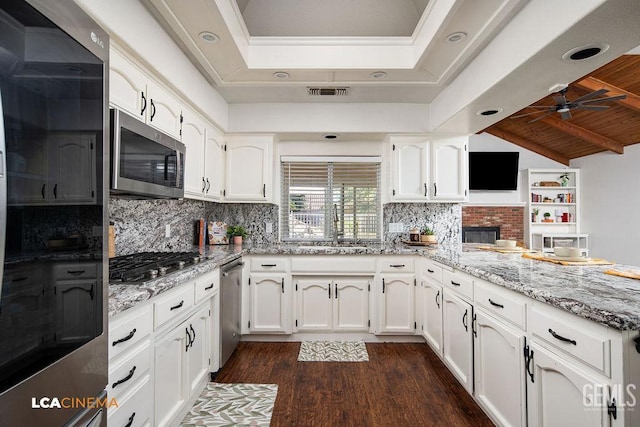 13019 Queen Palm Ct, Bakersfield, CA 93314 - kitchen with appliances with stainless steel finishes, dark wood finished floors, a ceiling fan, and white cabinetry
