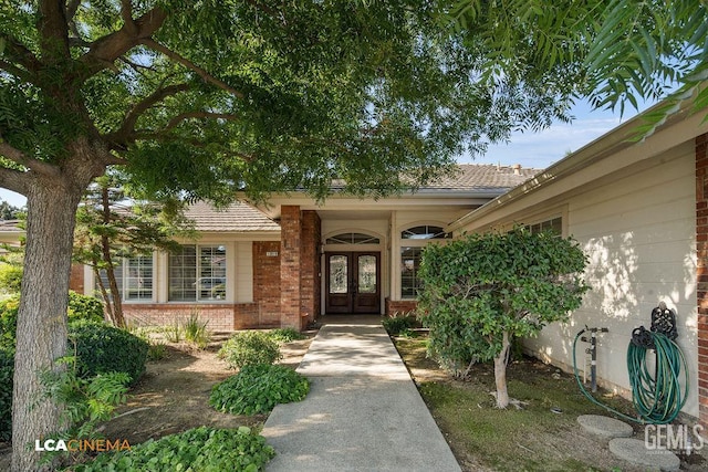 13019 Queen Palm Ct, Bakersfield, CA 93314 - doorway to property featuring french doors and brick siding