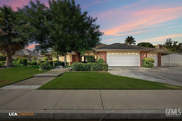 13019 Queen Palm Ct, Bakersfield, CA 93314 - ranch-style home featuring concrete driveway, a lawn, a garage, and brick siding