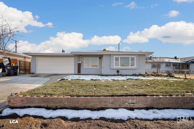 ranch-style home with a garage and a front lawn