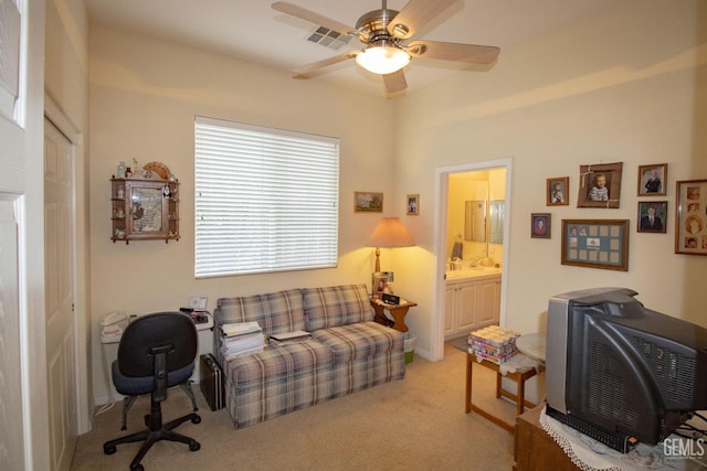 carpeted home office with ceiling fan