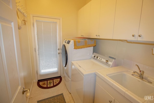 laundry room featuring cabinets, washer and dryer, and sink