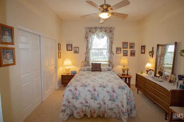 carpeted bedroom with ceiling fan and a closet