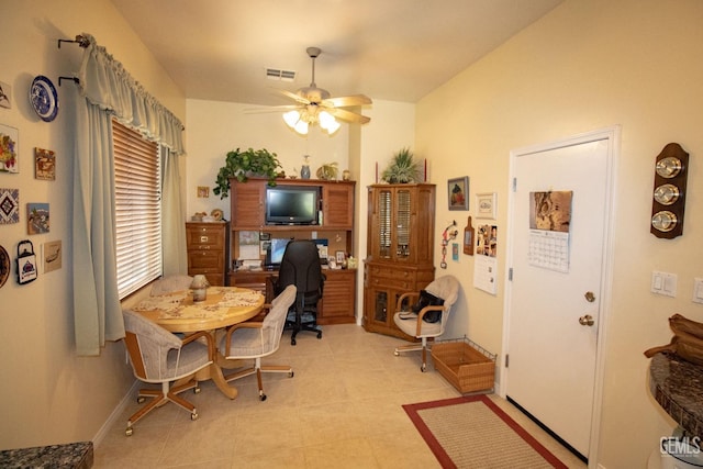 tiled dining space with ceiling fan