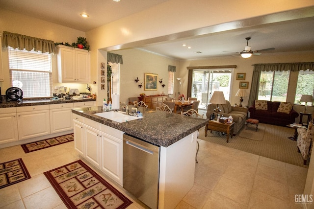 kitchen with sink, stainless steel dishwasher, an island with sink, ceiling fan, and white cabinets