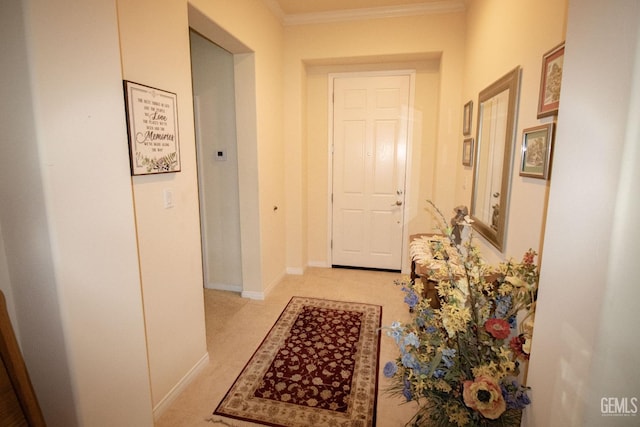 hallway featuring ornamental molding and light carpet