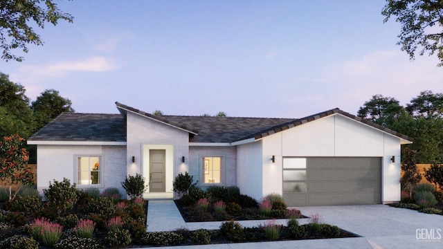 view of front of home with concrete driveway and a garage