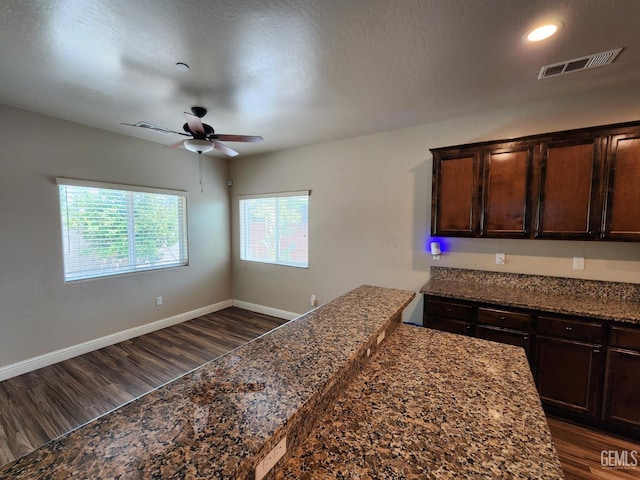 1756 Bautista Ave, Wasco, CA 93280 - kitchen with dark wood finished floors, ceiling fan, dark brown cabinets, dark stone counters, and recessed lighting