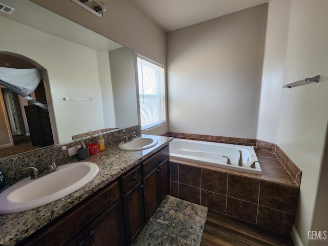 1756 Bautista Ave, Wasco, CA 93280 - bathroom with a garden tub, double vanity, and wood finished floors