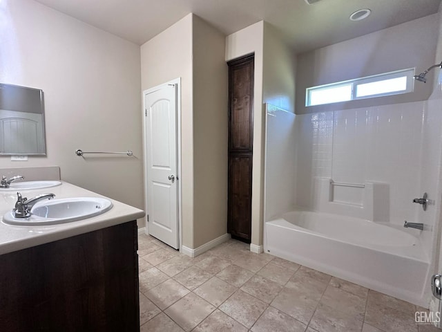 full bathroom featuring double vanity, tub / shower combination, and a sink
