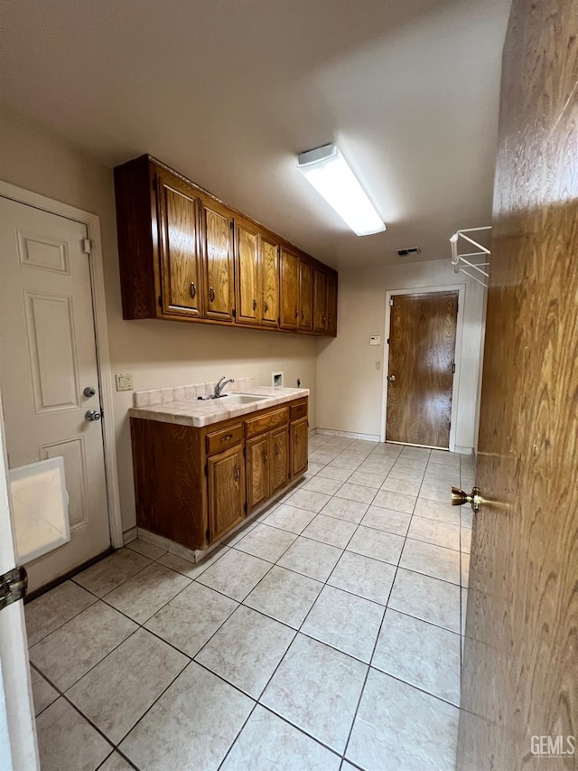 5306 Deville Ct, Bakersfield, CA 93308 - laundry area featuring cabinet space, washer hookup, and light tile patterned floors