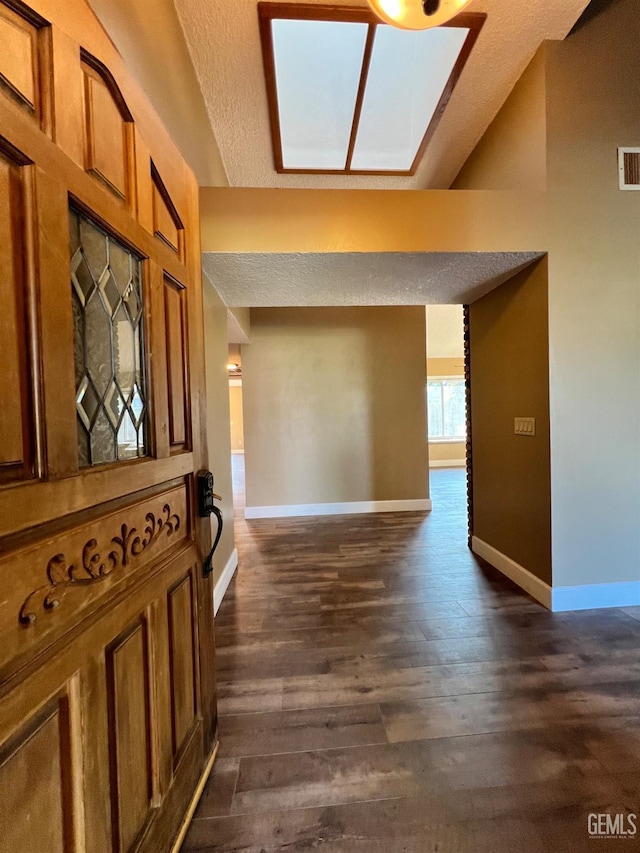 5306 Deville Ct, Bakersfield, CA 93308 - hall featuring dark wood finished floors, a textured ceiling, and a skylight
