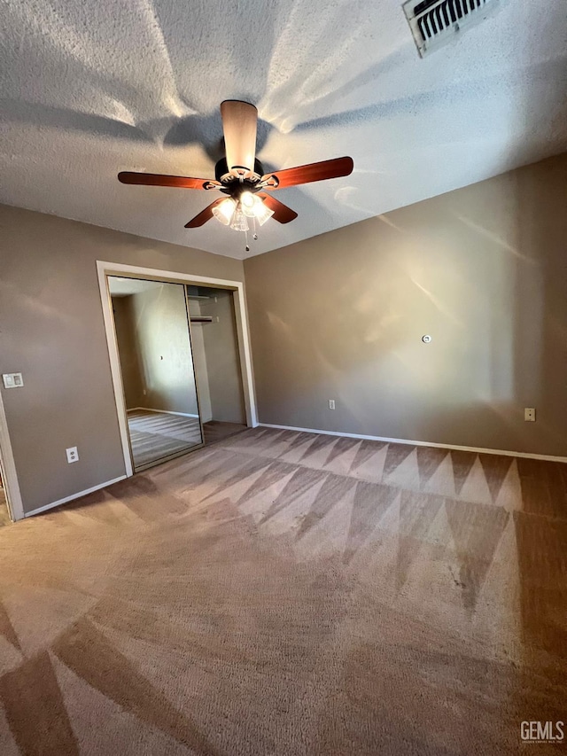 5306 Deville Ct, Bakersfield, CA 93308 - unfurnished bedroom with carpet, a closet, a ceiling fan, and a textured ceiling