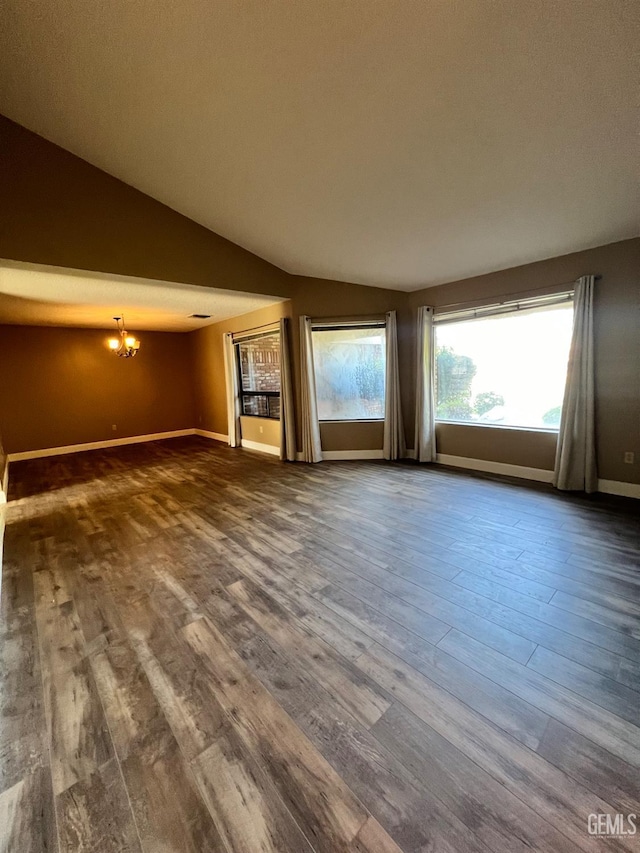 5306 Deville Ct, Bakersfield, CA 93308 - unfurnished living room with dark wood-style floors, a chandelier, and vaulted ceiling