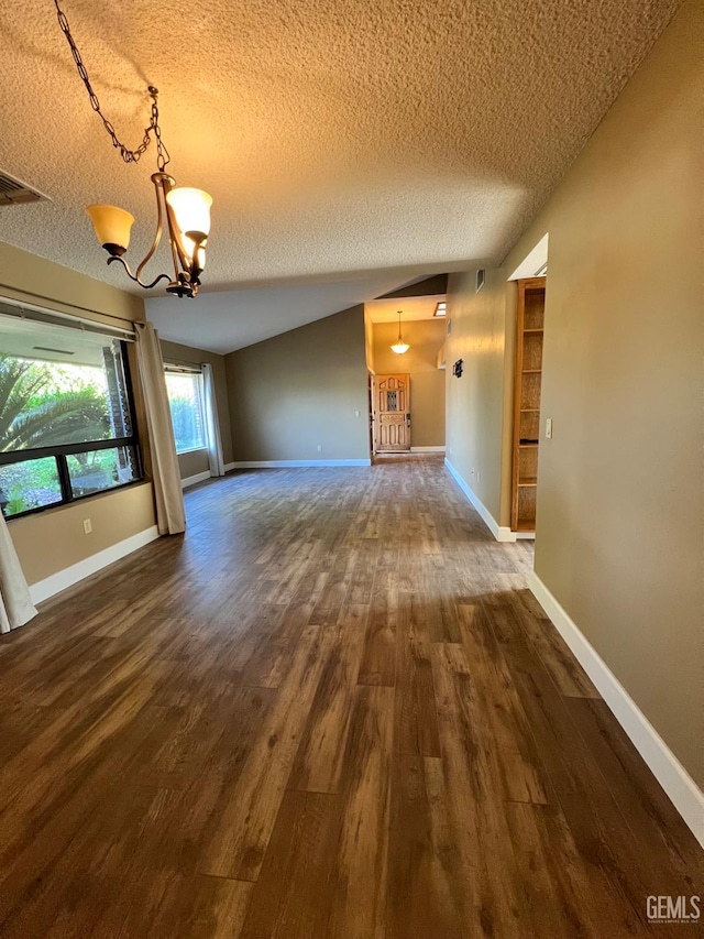 5306 Deville Ct, Bakersfield, CA 93308 - unfurnished room with a textured ceiling, a chandelier, vaulted ceiling, and dark wood-style floors