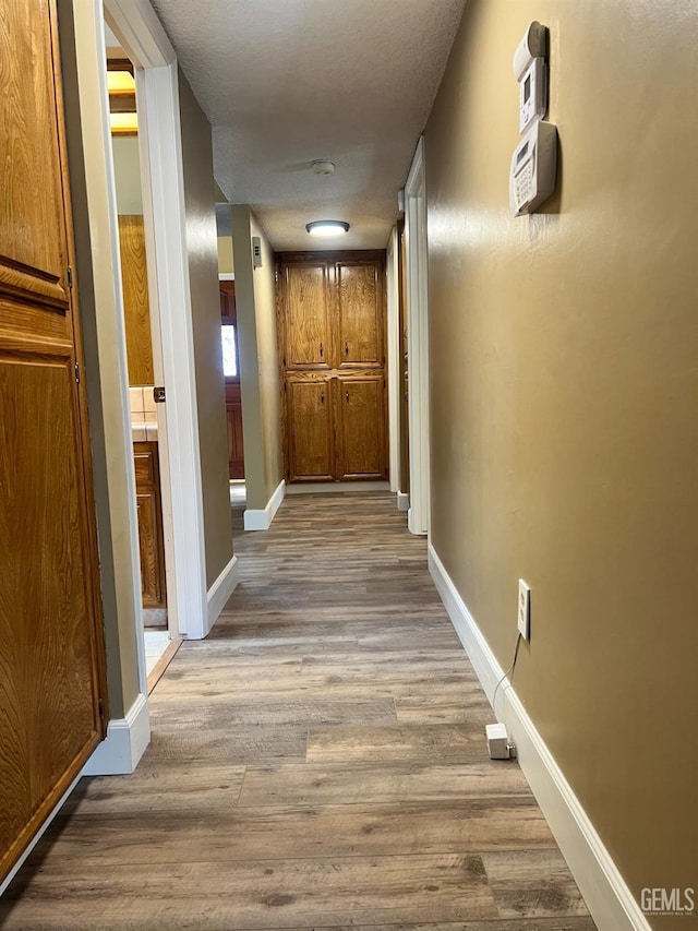 5306 Deville Ct, Bakersfield, CA 93308 - corridor featuring wood finished floors and baseboards