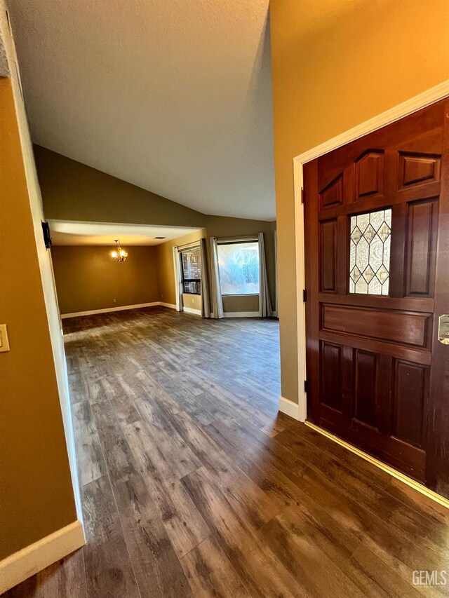 5306 Deville Ct, Bakersfield, CA 93308 - entryway with dark wood-style floors, lofted ceiling, and a chandelier
