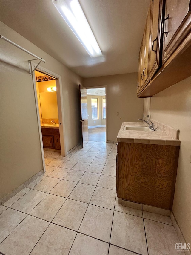 5306 Deville Ct, Bakersfield, CA 93308 - kitchen featuring tile counters, light tile patterned floors, and brown cabinets