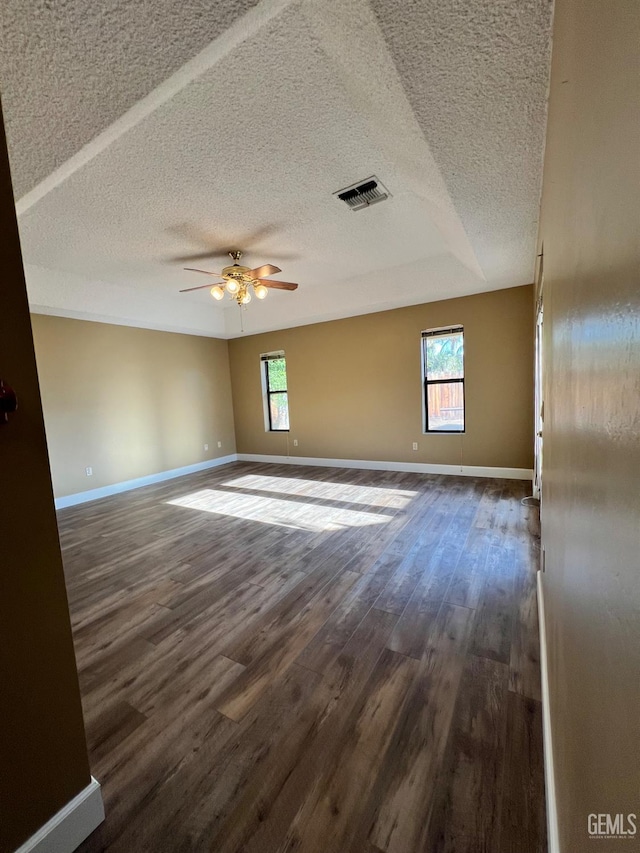 5306 Deville Ct, Bakersfield, CA 93308 - unfurnished room with a textured ceiling, dark wood finished floors, healthy amount of natural light, and a ceiling fan
