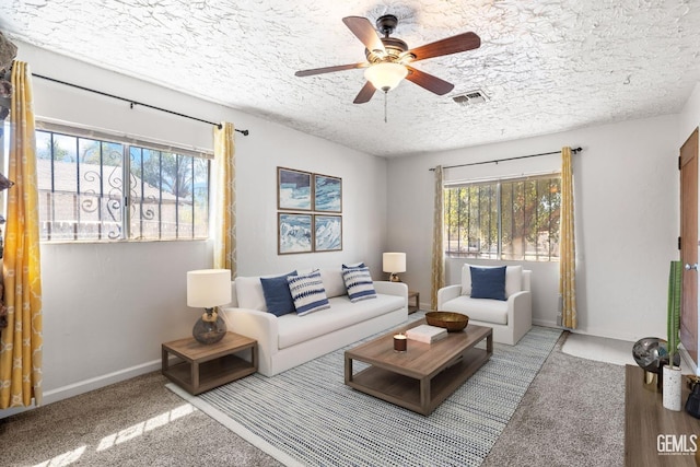 726 Belmont St, Delano, CA 93215 - living room featuring plenty of natural light, carpet, visible vents, and a ceiling fan