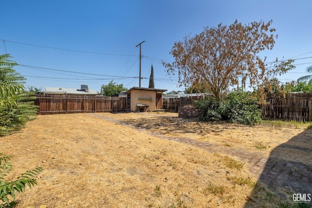726 Belmont St, Delano, CA 93215 - view of yard featuring a fenced backyard, a storage unit, and an outdoor structure