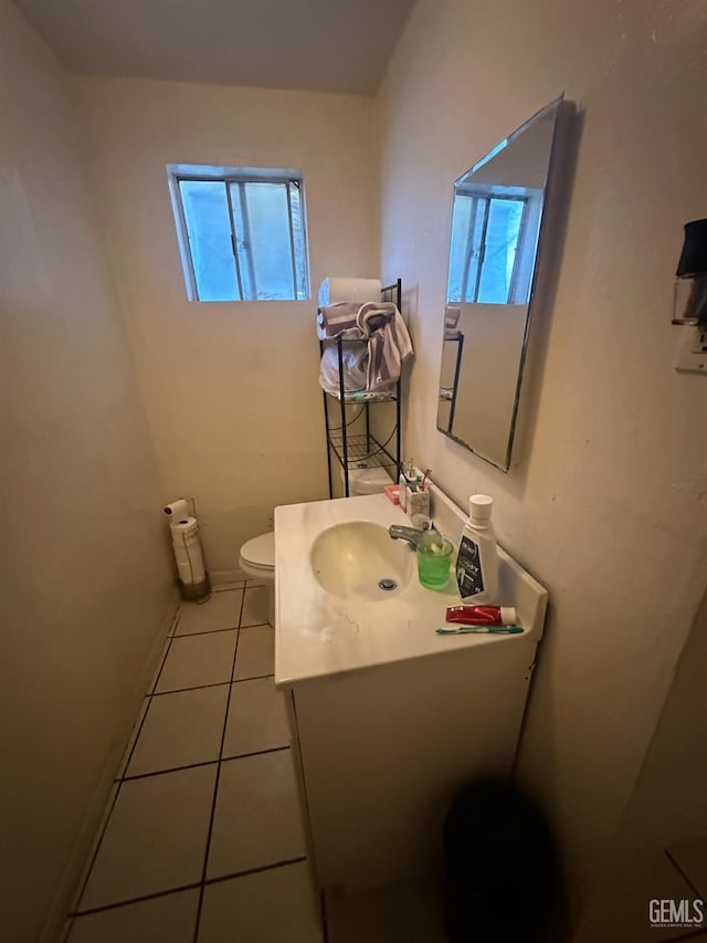 bathroom featuring toilet, tile patterned floors, and vanity